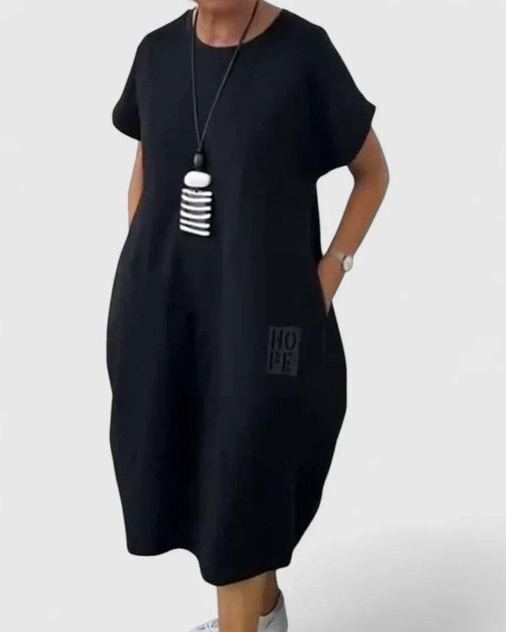 Effortless Black Midi Dress for Women with Crew Neck Short Sleeve Flowing Oversized Pockets Casual Style