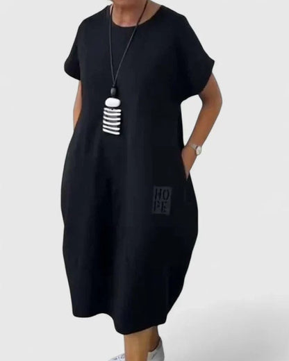 Effortless Black Midi Dress for Women with Crew Neck Short Sleeve Flowing Oversized Pockets Casual Style