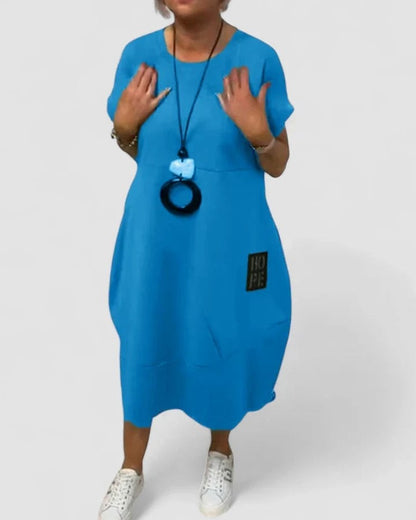 Effortless Black Midi Dress for Women with Crew Neck Short Sleeve Flowing Oversized Pockets Casual Style