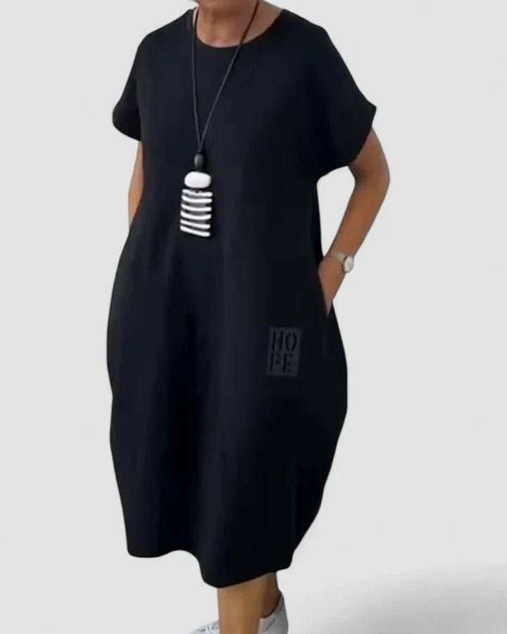 Effortless Black Midi Dress for Women with Crew Neck Short Sleeve Flowing Oversized Pockets Casual Style