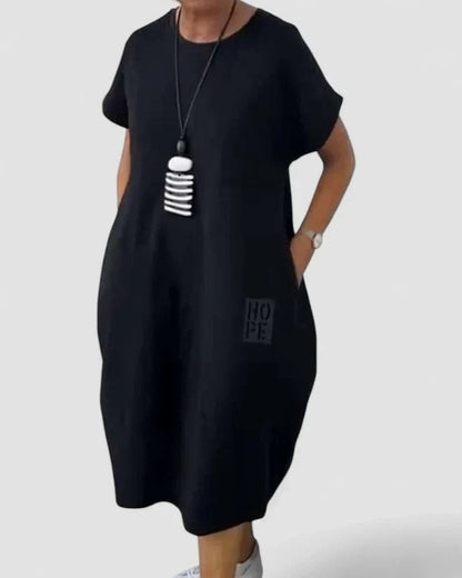 Effortless Black Midi Dress for Women with Crew Neck Short Sleeve Flowing Oversized Pockets Casual Style